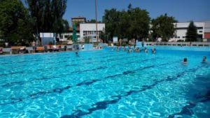 Veľký bazén na Termálnom kúpalisku Komárno, v ktorom plávajú ľudia.